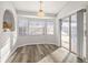 Sunlit dining area with wood-look flooring and sliding glass doors at 8404 Millwood Dr, Hudson, FL 34667