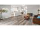 Open concept living room with wood-look floors and kitchen view at 8404 Millwood Dr, Hudson, FL 34667