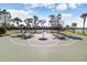 Outdoor basketball court with a hoop, surrounded by tall palm trees, under a clear sky at 9407 Channing Hill Dr, Ruskin, FL 33573