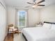 Bright bedroom with a large window, ceiling fan, and a chair, offering a cozy space for rest and relaxation at 9407 Channing Hill Dr, Ruskin, FL 33573