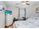 Well-lit bedroom with wooden floors, a TV, a work desk, and a comfortable bed at 9407 Channing Hill Dr, Ruskin, FL 33573