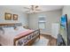 Cozy bedroom with wood floors, a ceiling fan, and natural light, offering a serene retreat at 9407 Channing Hill Dr, Ruskin, FL 33573