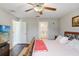 Cozy bedroom featuring a ceiling fan and an ensuite bathroom at 9407 Channing Hill Dr, Ruskin, FL 33573