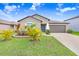 Charming single-story home with a well-manicured lawn and a two-car garage, perfect for suburban living at 9407 Channing Hill Dr, Ruskin, FL 33573