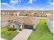 Aerial view of a well-maintained home with manicured lawn and convenient two-car garage in a Gathering-friendly neighborhood at 9407 Channing Hill Dr, Ruskin, FL 33573