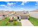 Inviting single-story home boasts a manicured lawn and an attached two-car garage, with beautiful landscaping at 9407 Channing Hill Dr, Ruskin, FL 33573