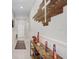 Bright hallway with white walls, tile flooring, and decorative wood cross on the wall at 9407 Channing Hill Dr, Ruskin, FL 33573