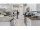 Modern kitchen featuring granite countertops, stainless steel appliances, and white cabinetry, designed for culinary enthusiasts at 9407 Channing Hill Dr, Ruskin, FL 33573