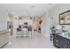 Open floor plan featuring a kitchen with stainless steel appliances, white cabinets, and bar seating at 9407 Channing Hill Dr, Ruskin, FL 33573