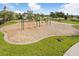 Community playground with swings, slides, and open green spaces for recreation at 9407 Channing Hill Dr, Ruskin, FL 33573