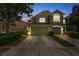 Two-story house with two car garage at dusk at 10217 Red Currant Ct, Riverview, FL 33578