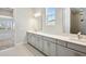 Bathroom featuring a large vanity, shower, and access to the bedroom at 17525 Glistening Ct, Venice, FL 34293