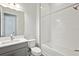 Bathroom featuring a shower-tub combo and granite countertop on vanity at 17525 Glistening Ct, Venice, FL 34293