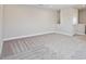 Bright bedroom showcasing neutral walls, carpet, with a door leading to other areas of the home at 17525 Glistening Ct, Venice, FL 34293