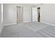 Bedroom featuring neutral carpet, white trim, and an ensuite bathroom at 17525 Glistening Ct, Venice, FL 34293