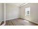 Bright bedroom features wood-look floors, base trim and a window for natural light at 17525 Glistening Ct, Venice, FL 34293