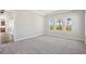 Spacious bedroom with light gray carpet and multiple windows for natural light at 17525 Glistening Ct, Venice, FL 34293