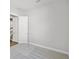 Empty bedroom with plush carpet, a door to the hallway and a large blank wall at 17525 Glistening Ct, Venice, FL 34293