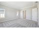 Bright bedroom with a tray ceiling, neutral carpet, and bright natural lighting at 17525 Glistening Ct, Venice, FL 34293