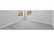 Well-lit bedroom with neutral walls, soft carpet, and windows providing natural light at 17525 Glistening Ct, Venice, FL 34293