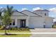 Beautiful one-story home with a three car garage, manicured lawn and covered porch entrance at 17525 Glistening Ct, Venice, FL 34293