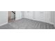 Hallway featuring carpet, white trim, and storage closet at 17525 Glistening Ct, Venice, FL 34293
