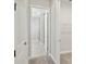Hallway featuring neutral paint with doorways to the bathroom and walk in closet at 17525 Glistening Ct, Venice, FL 34293