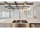 Open-concept kitchen with stainless steel appliances, a large island, and view of the living room at 17525 Glistening Ct, Venice, FL 34293