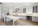 Modern kitchen with stainless steel appliances, a large island, and light gray cabinetry at 17525 Glistening Ct, Venice, FL 34293