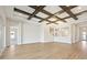 Expansive living room with coffered ceilings, wood floors, staircase, and access to a private area at 17525 Glistening Ct, Venice, FL 34293