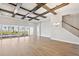 Spacious living room with coffered ceilings, wood floors, and sliding glass doors to the pool at 17525 Glistening Ct, Venice, FL 34293