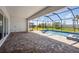 Screened-in lanai with brick flooring, a private pool, and a view of the surrounding backyard at 17525 Glistening Ct, Venice, FL 34293