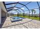 Screened-in lanai featuring a pool, surrounding lush landscaping, and a tiled pool at 17525 Glistening Ct, Venice, FL 34293