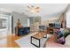 Versatile bonus room with a leather couch and a work area at 1858 Longview Ln, Tarpon Springs, FL 34689