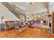 Spacious living room with hardwood floors, a view of the kitchen and staircase at 1858 Longview Ln, Tarpon Springs, FL 34689