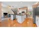 Spacious kitchen with island, stainless steel appliances, and hardwood floors at 1858 Longview Ln, Tarpon Springs, FL 34689
