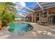 Inviting screened pool area with a patio and outdoor dining at 1858 Longview Ln, Tarpon Springs, FL 34689