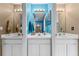 Shared bathroom with double sink vanity and blue walls at 1858 Longview Ln, Tarpon Springs, FL 34689