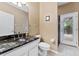 Bathroom with granite countertop, shower, and access to backyard pool at 1858 Longview Ln, Tarpon Springs, FL 34689
