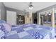 Spacious bedroom with a large bed, built-in shelving, and mirrored closet doors at 1858 Longview Ln, Tarpon Springs, FL 34689