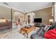 Spacious living room with leather sofas, hardwood floors, and large windows at 1858 Longview Ln, Tarpon Springs, FL 34689
