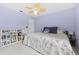 Lavender bedroom with a large bed, ceiling fan, and built-in shelving at 1858 Longview Ln, Tarpon Springs, FL 34689