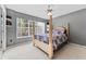 Guest bedroom with a post bed and large window at 1858 Longview Ln, Tarpon Springs, FL 34689
