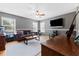 Bright bonus room with a leather couch and home office space at 1858 Longview Ln, Tarpon Springs, FL 34689
