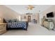 Primary bedroom featuring a ceiling fan and ensuite bathroom access at 1858 Longview Ln, Tarpon Springs, FL 34689