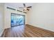 Bedroom with wood floors and sliding glass doors to balcony at 220 Woodlake Wynde # 220, Oldsmar, FL 34677