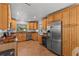 Spacious kitchen with wood cabinets, granite counters, and stainless steel appliances at 2516 Roberta St, Largo, FL 33771