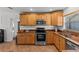 Modern kitchen featuring stainless steel appliances and wood cabinets at 2516 Roberta St, Largo, FL 33771