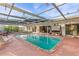 Inviting pool area with covered patio, lounge chairs, and a swing at 2516 Roberta St, Largo, FL 33771