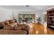 Living room with hardwood floors, sliding glass doors leading to the pool area at 2516 Roberta St, Largo, FL 33771